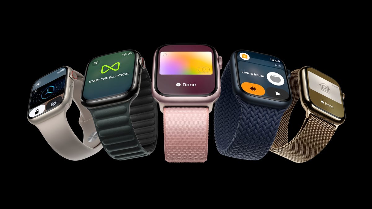 A variety of apple watches on black, pink in the middle